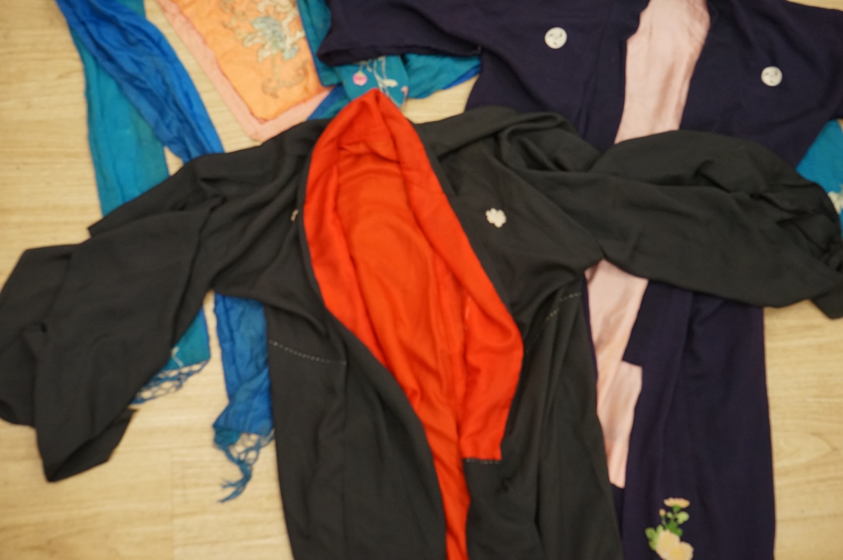 A collection of Chinese and Japanese embroidered kimonos and textiles